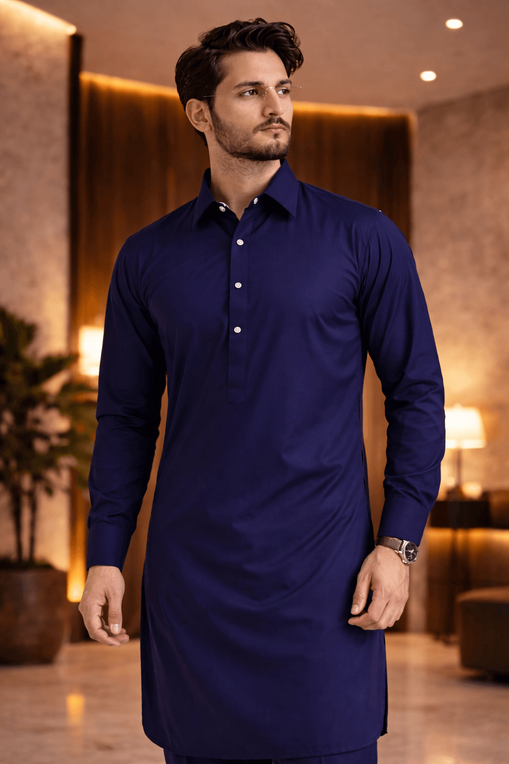 Navy blue shalwar kameez showcasing men's traditional attire in a modern setting.