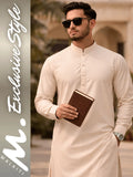 Man wearing a beige kurta holding a book with walaiti. Exclusive Style' branding.