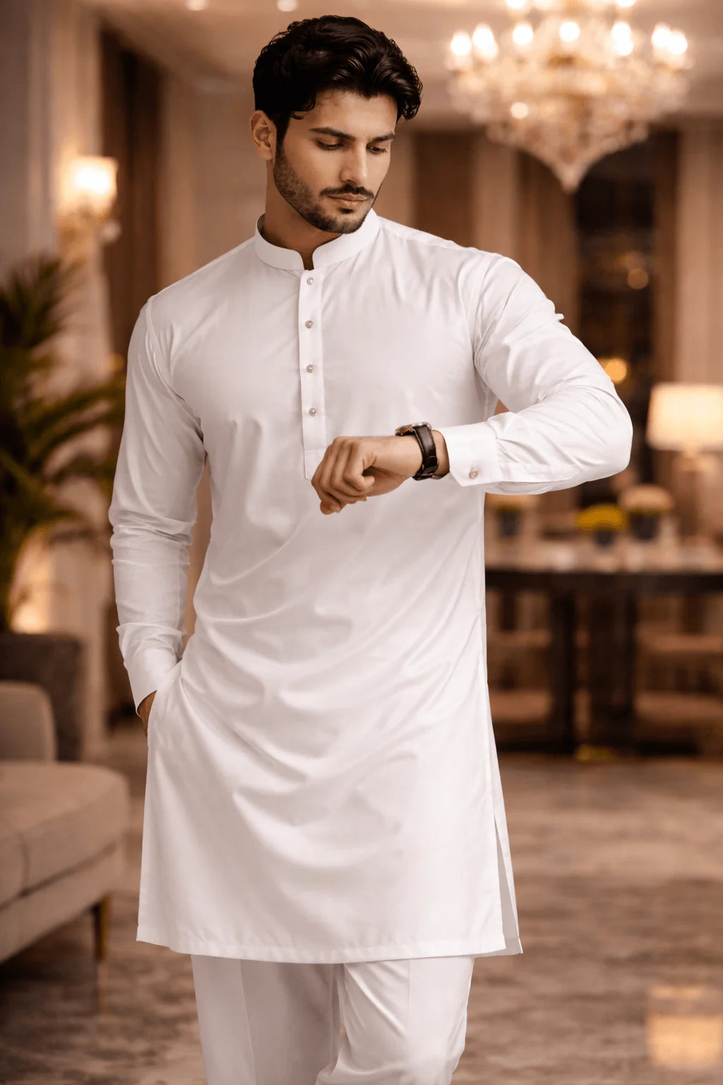 Man wearing a white kurta in an indoor setting