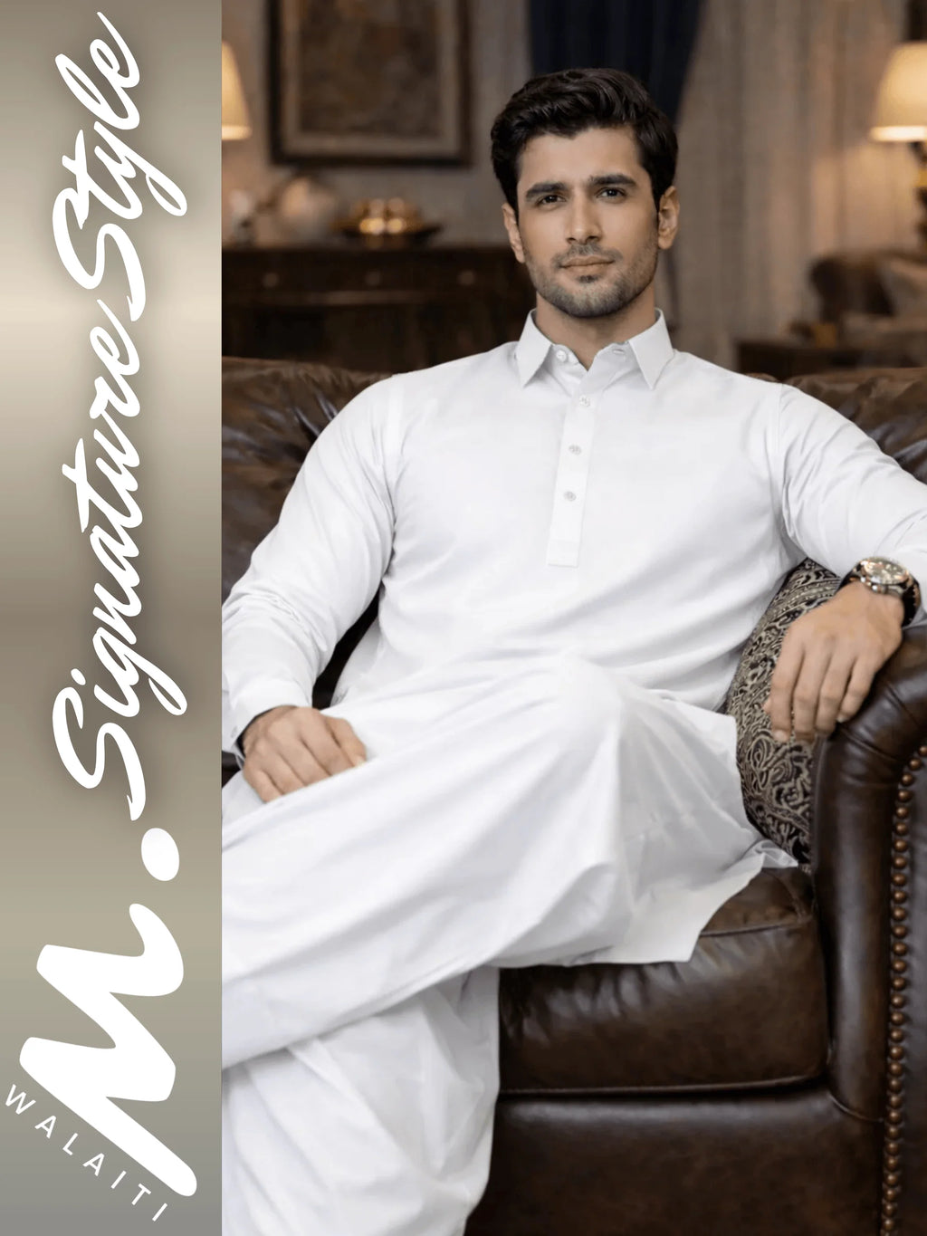 Man in white traditional outfit sitting on a brown leather couch with 'walaiti. Signature Style' branding.