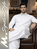 Man in white traditional outfit sitting on a brown leather couch with 'walaiti. Signature Style' branding.