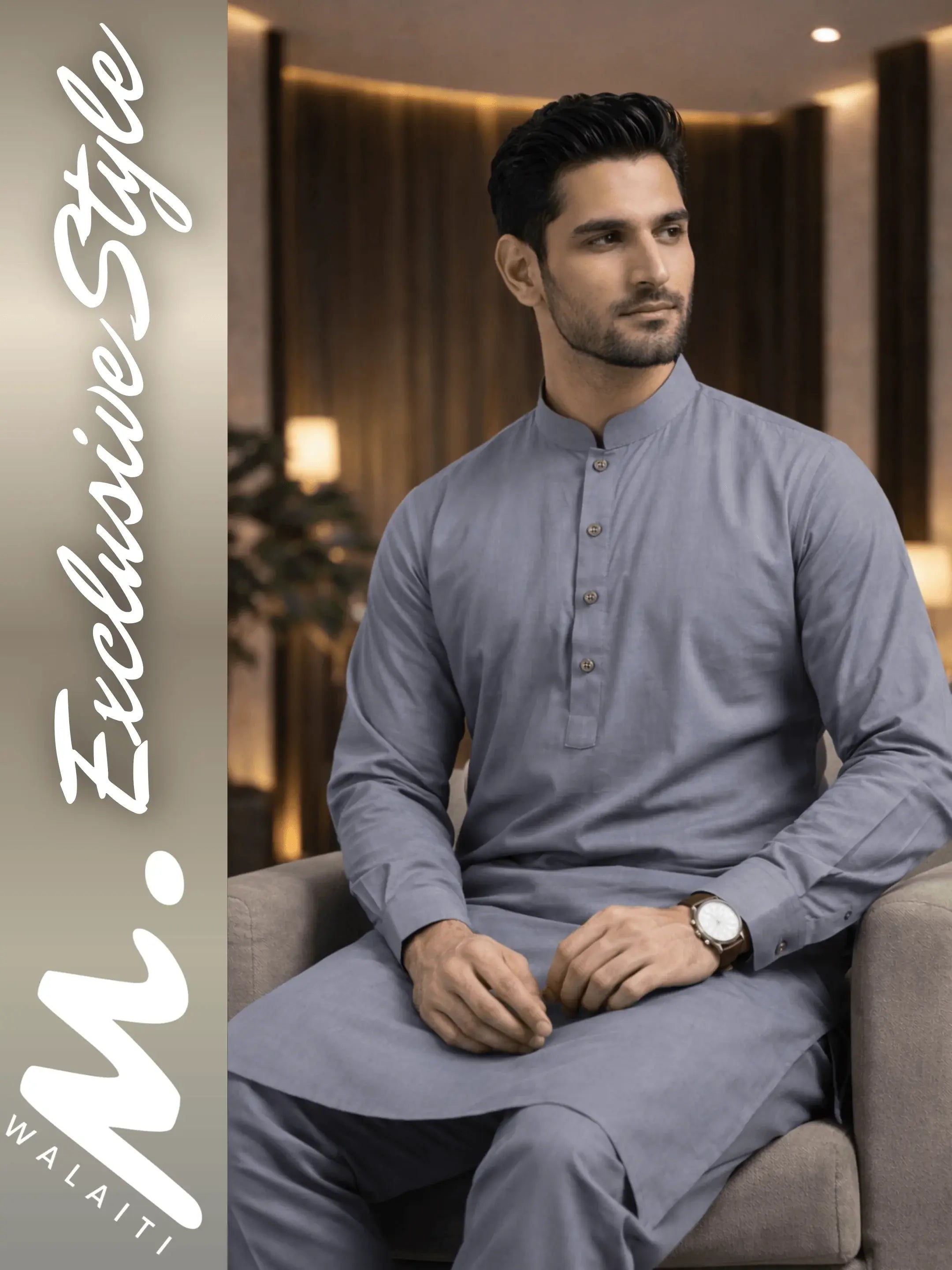 Man wearing a gray kurta sitting on a couch in a well-lit room with walaiti Exclusive Style' branding.